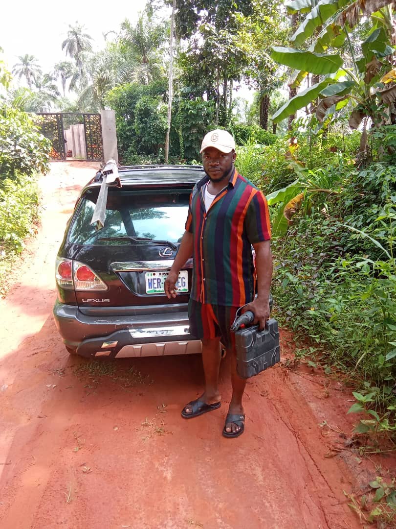 Sharlon Chukwuma working on window fabrication in Owerri workshop